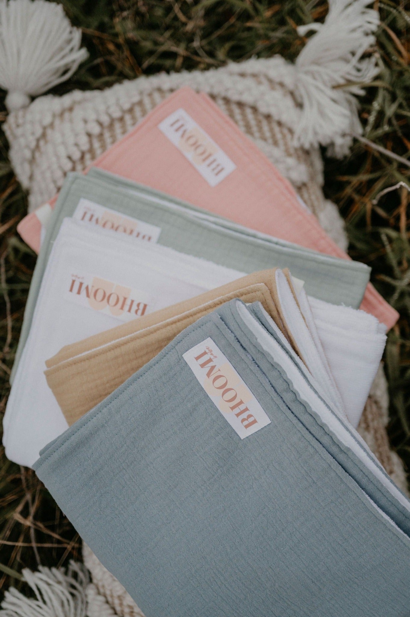 Folded range of BHOOMI Babe tie up burp cloth and nursing covers in blue, mustard, white, pink and green