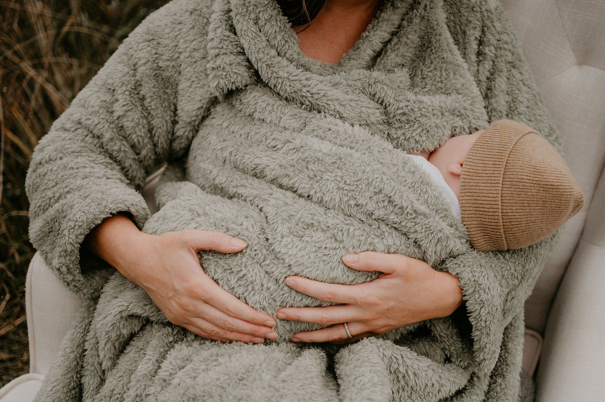 Mother breastfeeding her baby in a BHOOMI Breastfeeding Blanket