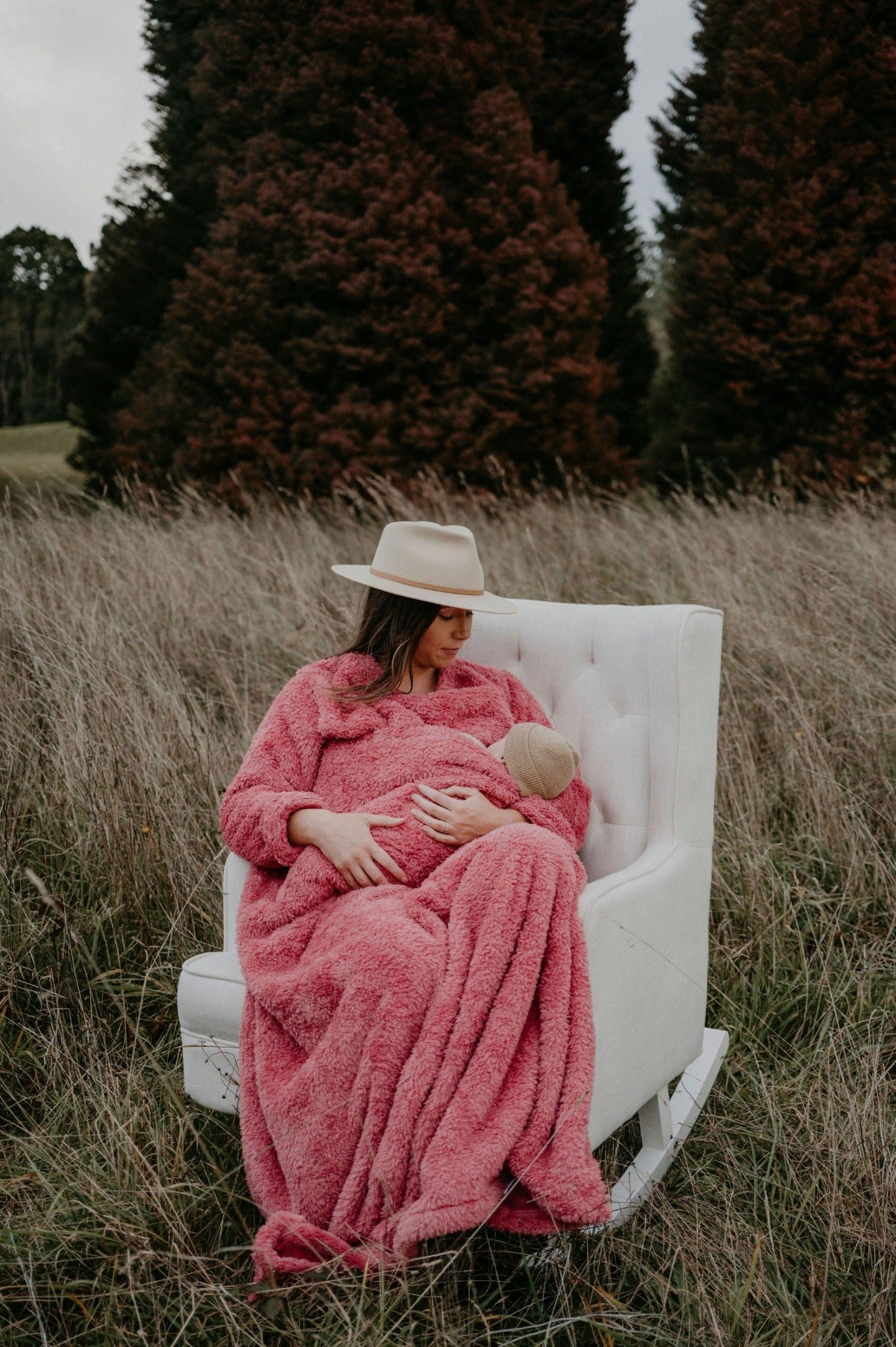 Mother breastfeeding her baby in a plum BHOOMI Blanket