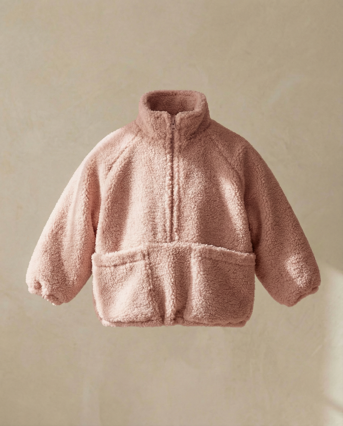 Pink fleece jacket on a light green background