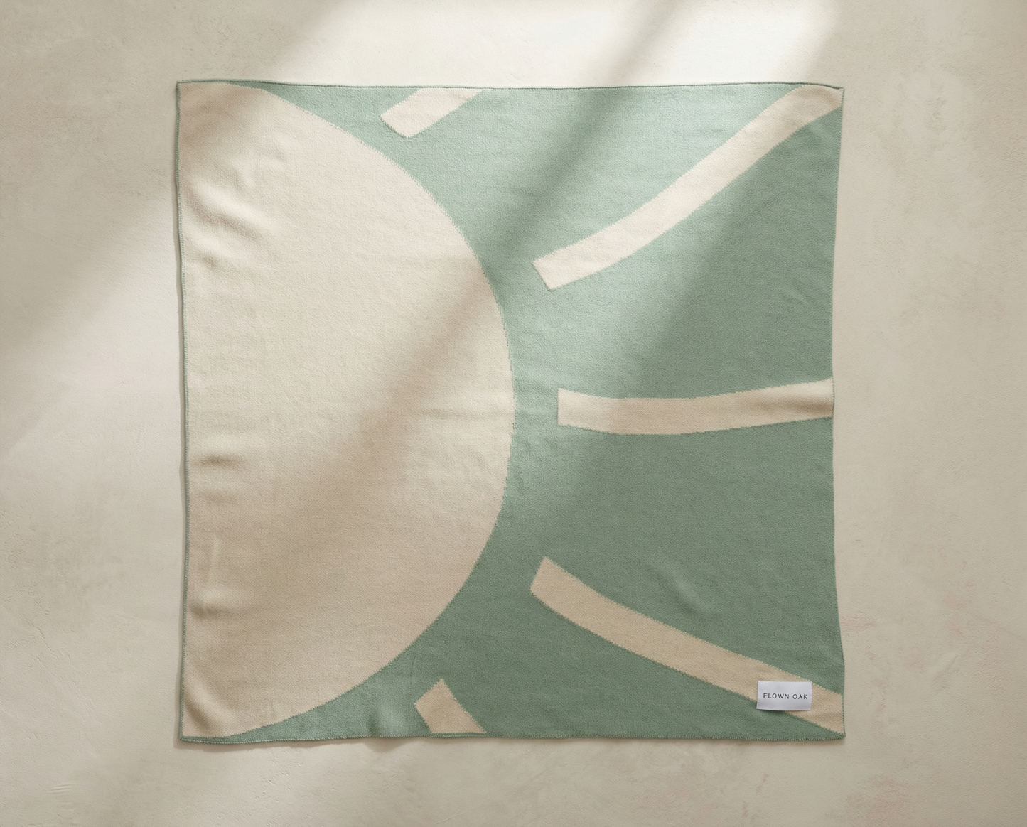 Green and beige patterned fabric on a beige background
