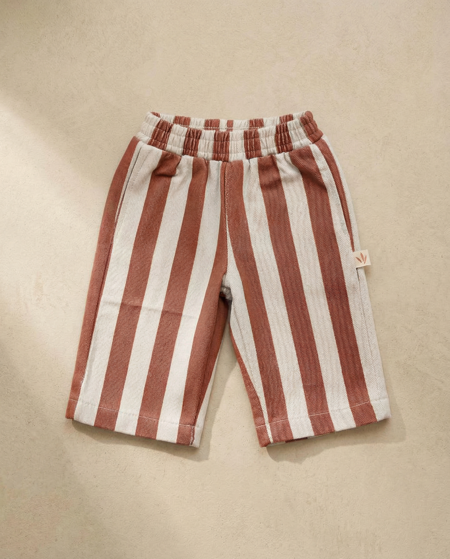 Red and white striped shorts on a beige background