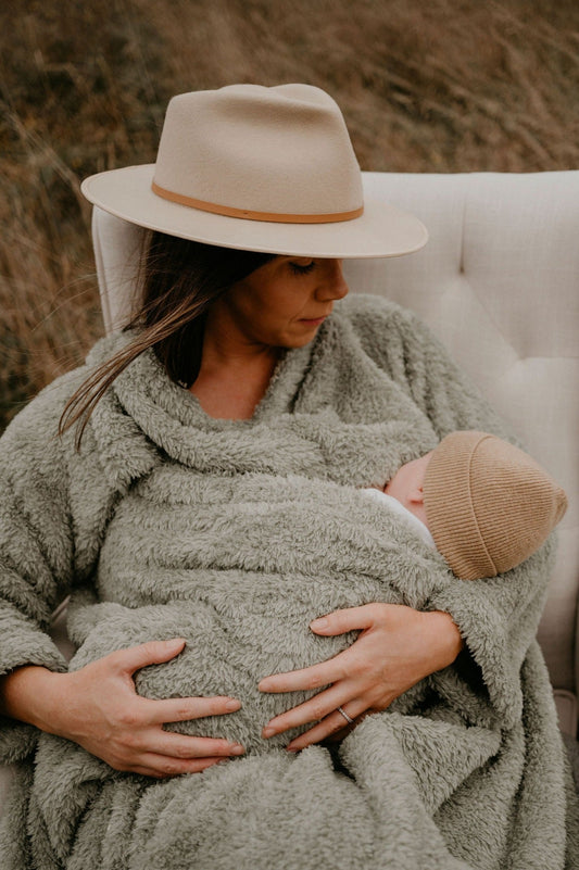 Mother breastfeeding her baby in a Sage Green BHOOMI Breastfeeding Blanket