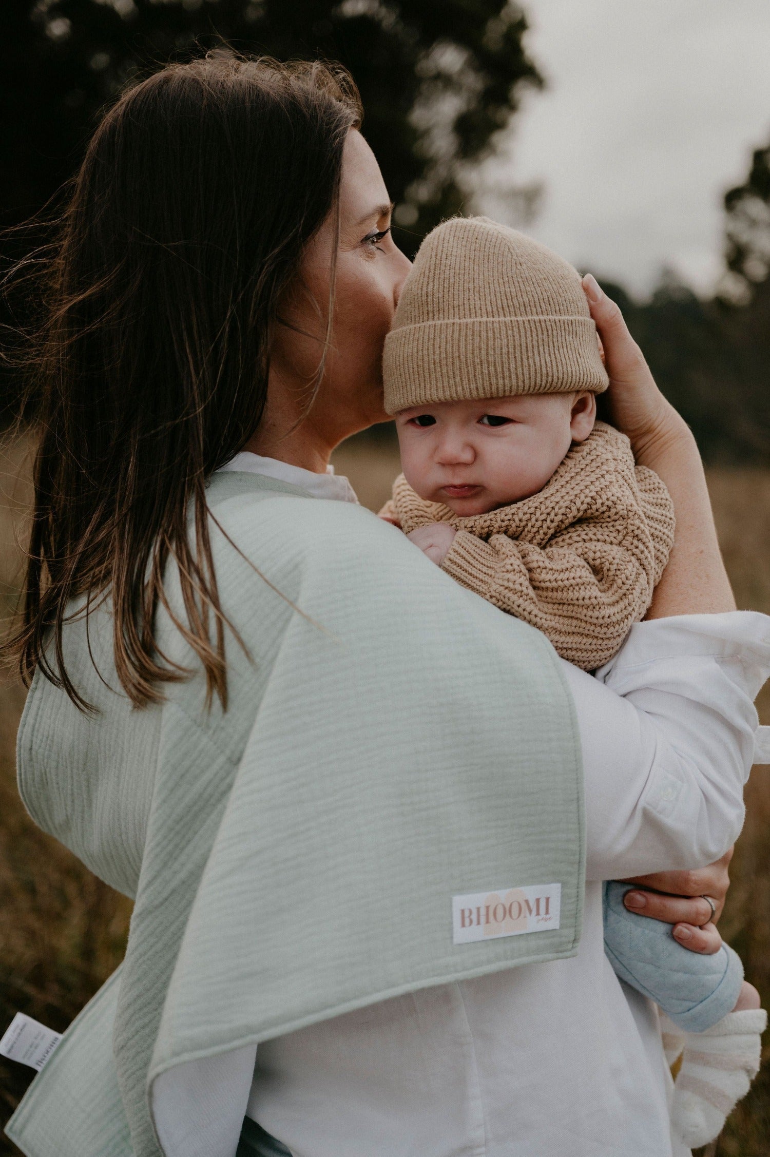 New Mum burping her baby using a tie up burp cloth