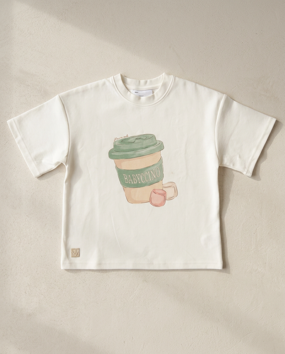 White t-shirt with a coffee cup graphic on a beige background