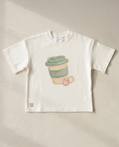 White t-shirt with a coffee cup graphic on a beige background