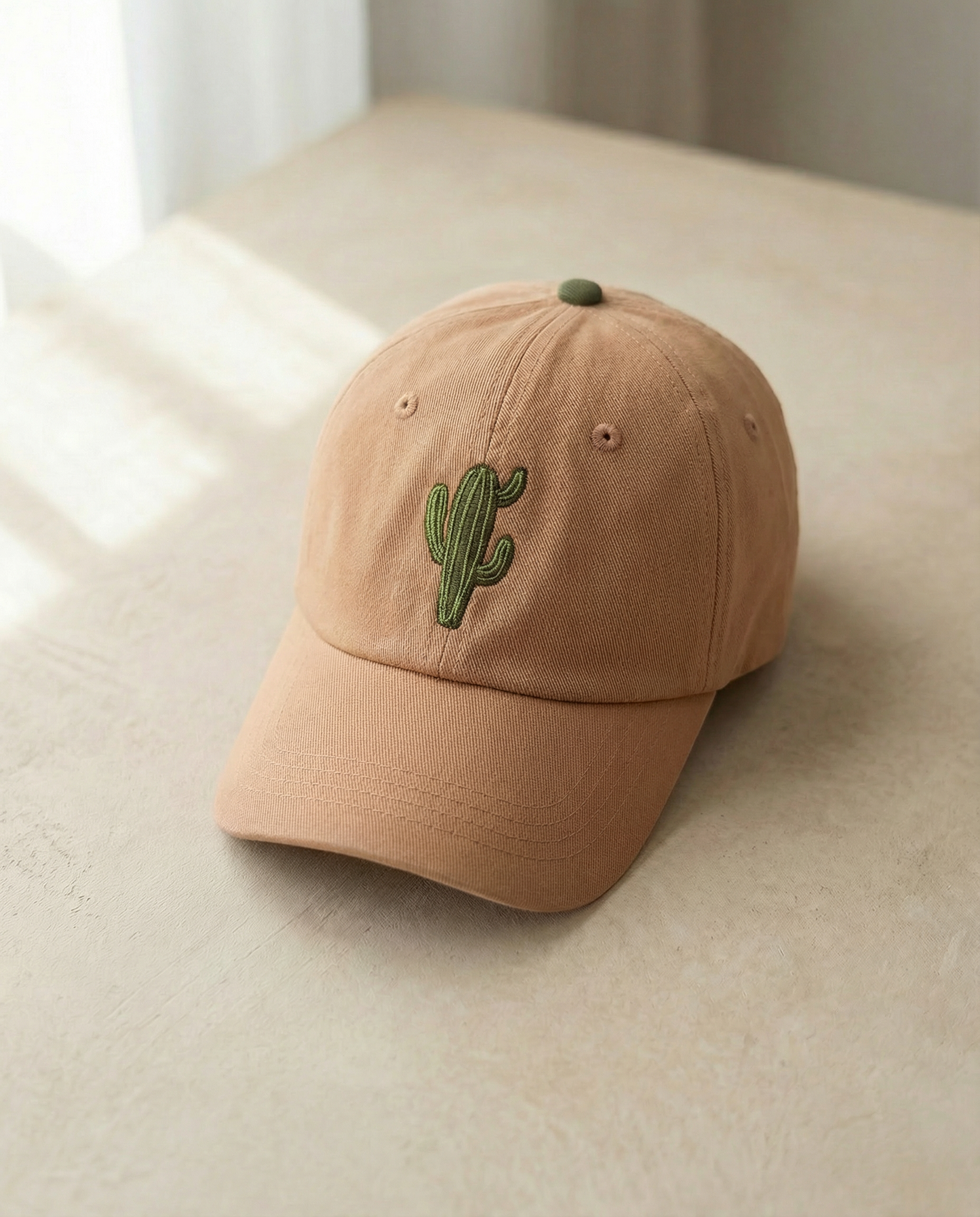 Beige cap with a cactus embroidery on a light surface