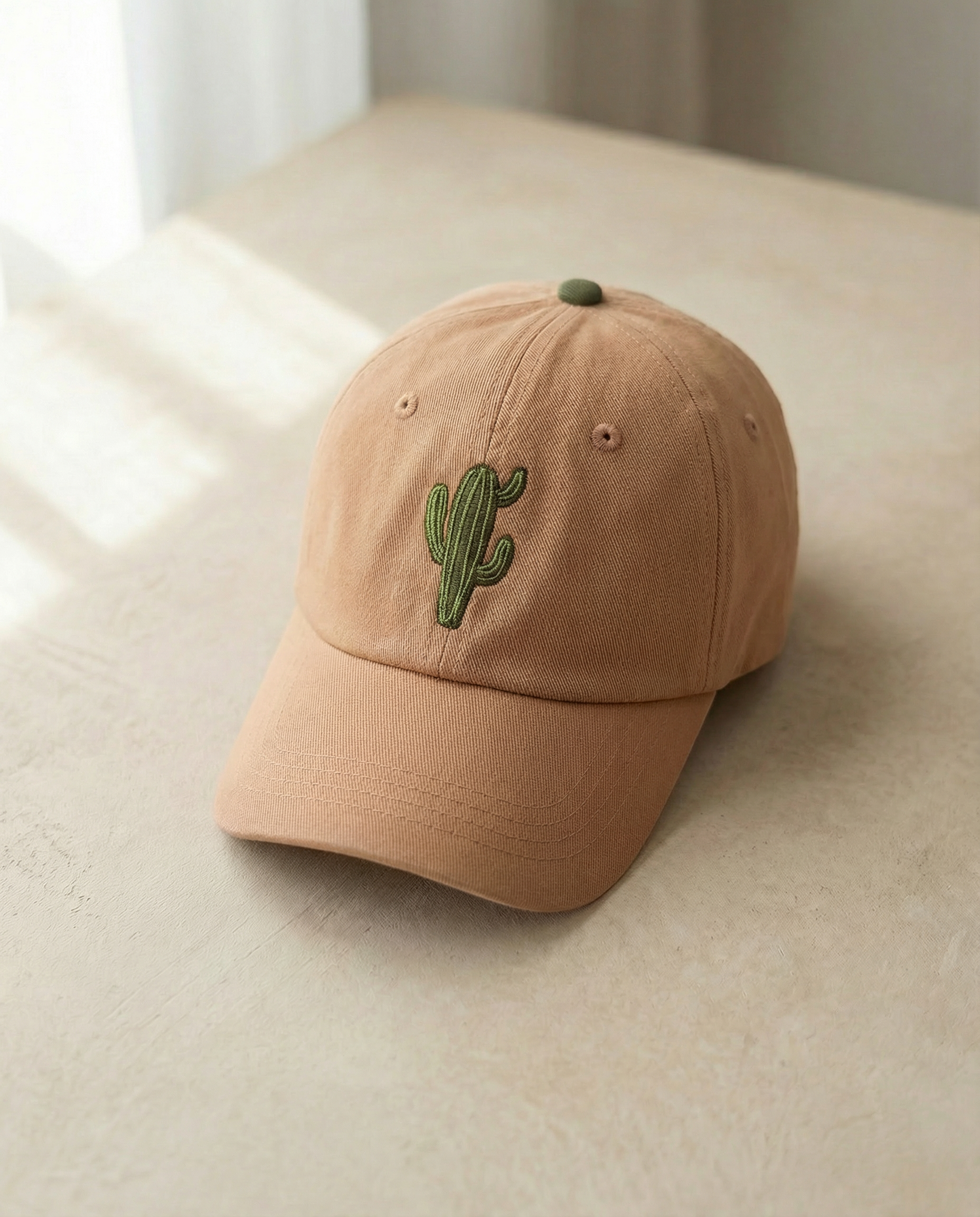 Beige cap with a cactus embroidery on a light surface