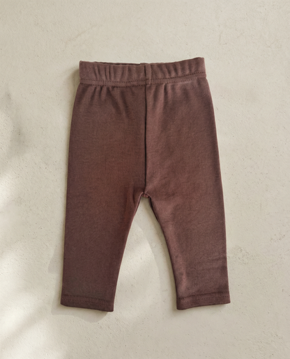 Brown baby leggings on a beige background
