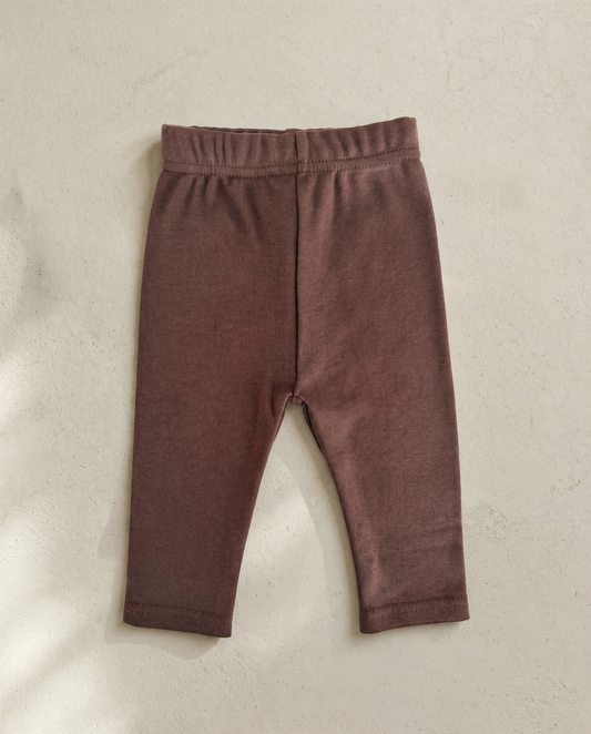 Brown baby leggings on a beige background