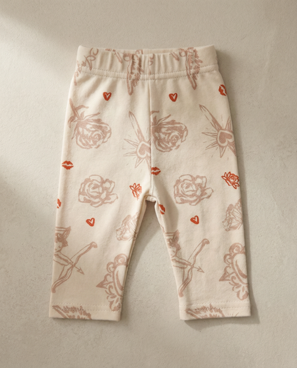 Baby leggings with red floral patterns on a beige background