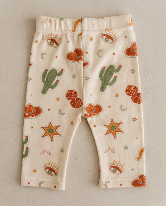 Baby leggings with cactus and star pattern on a plain background
