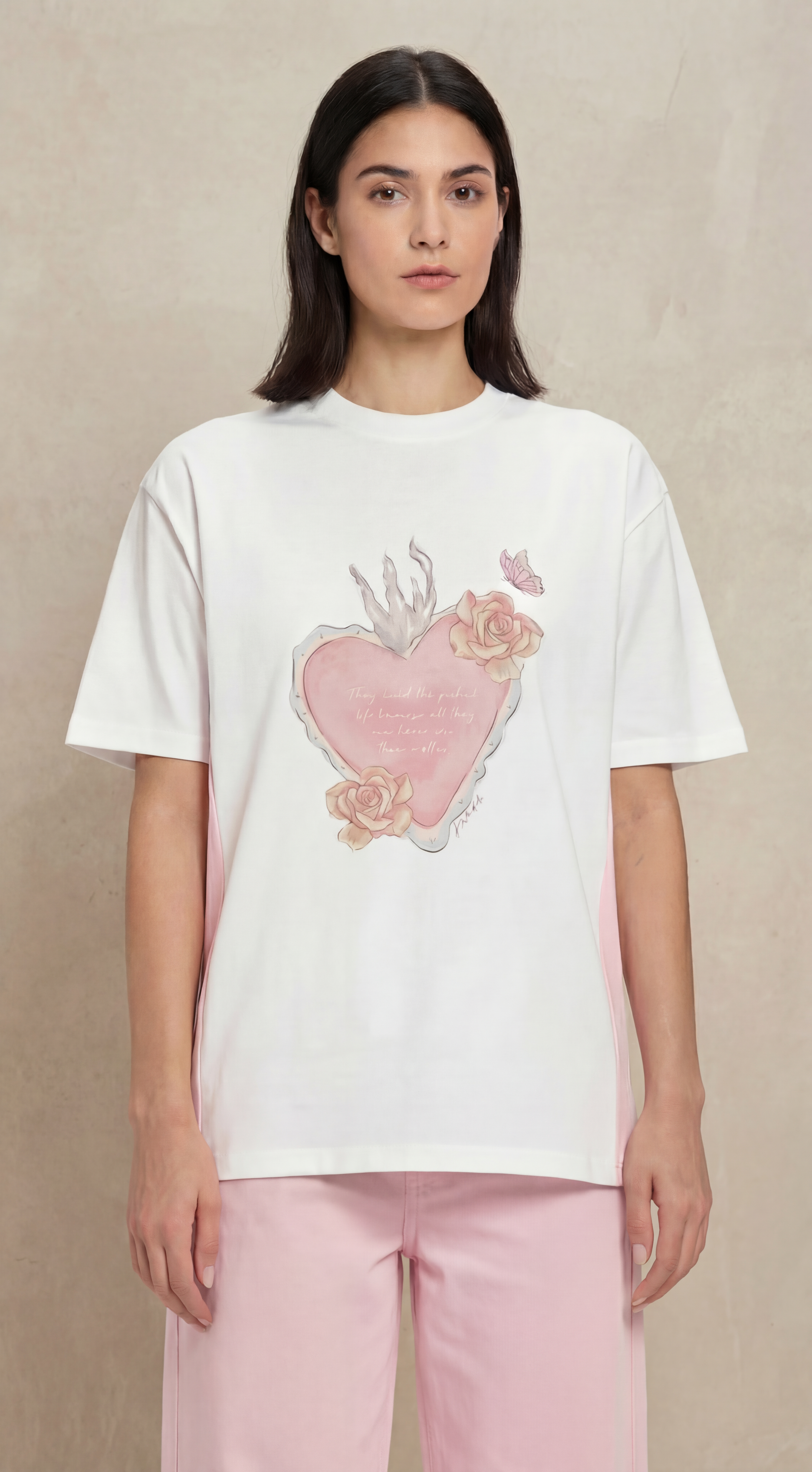 Woman wearing a white t-shirt with a pink floral design on a beige background