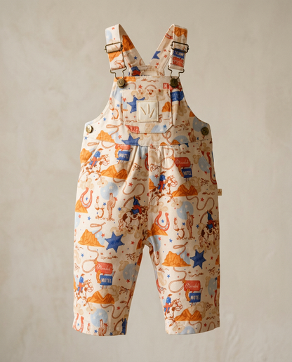 Children's overalls with colorful pattern on a beige background