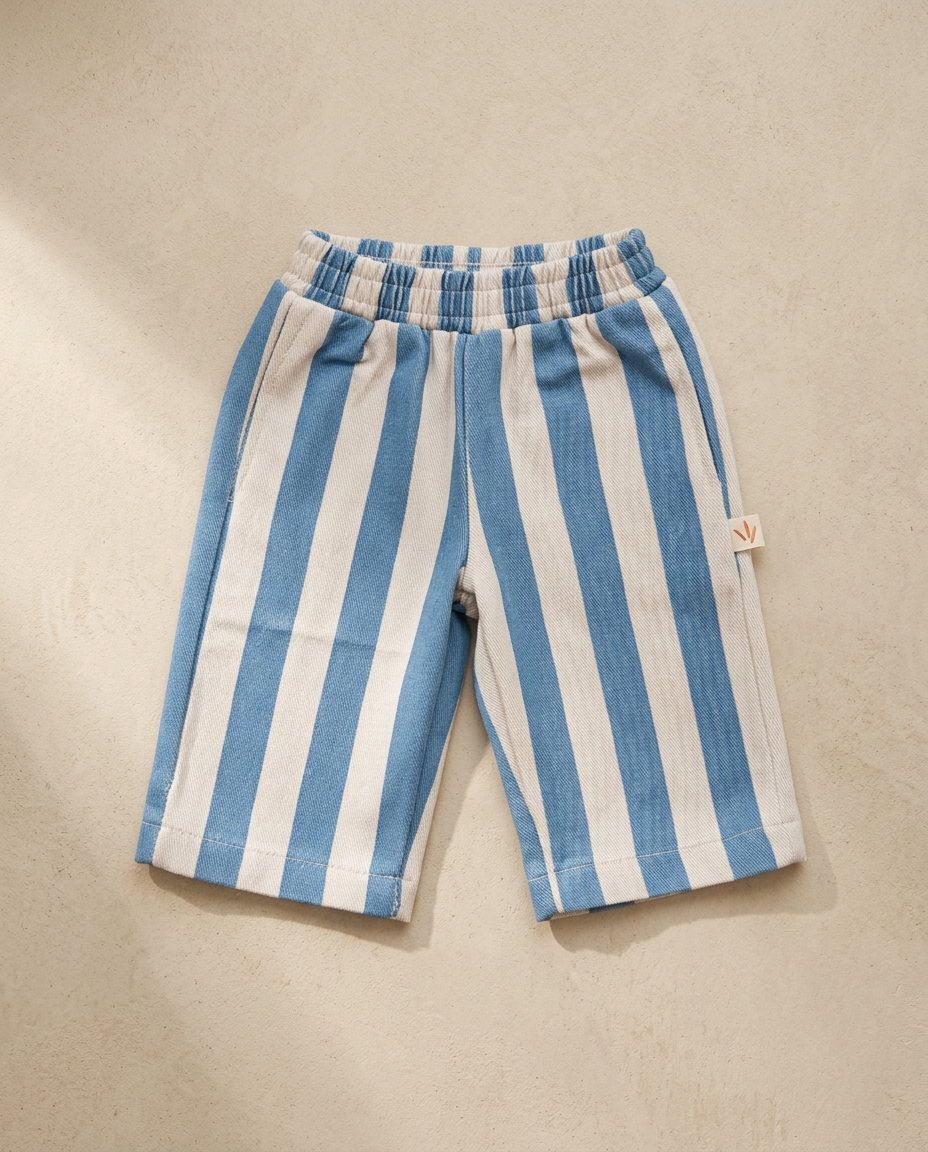 Blue and white striped shorts on a beige background