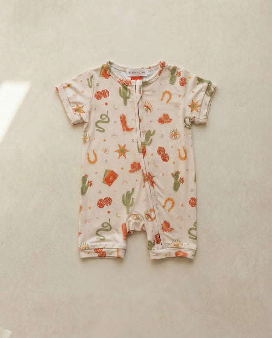 Baby onesie with cowboy-themed print on a light background