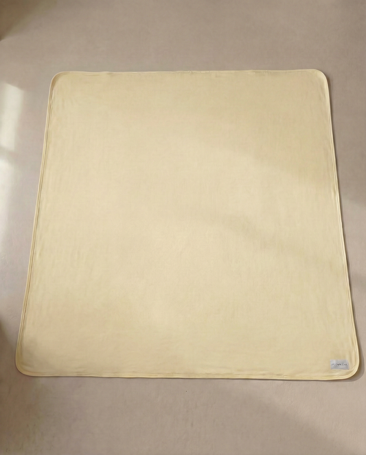 yellow swaddle on a beige surface