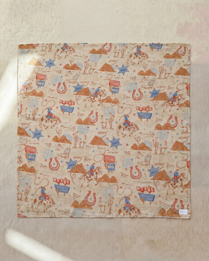 Fabric with cowboy-themed pattern on a beige background
