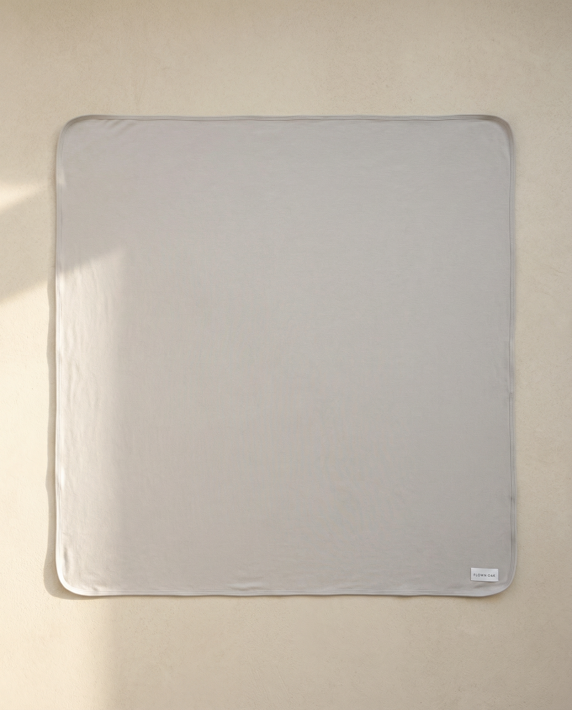 Pale blue swaddle on a beige background