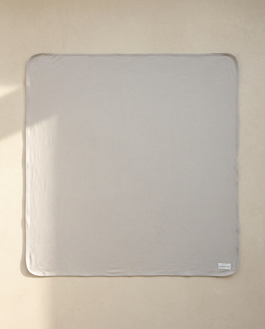 Pale blue swaddle on a beige background
