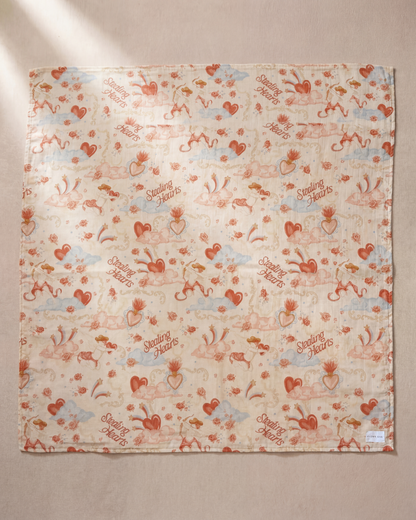 Patterned fabric with hearts and text on a beige background