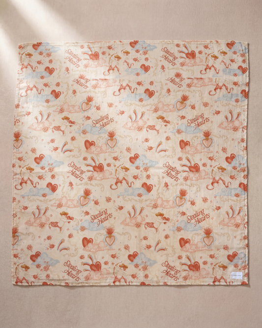 Patterned fabric with hearts and text on a beige background