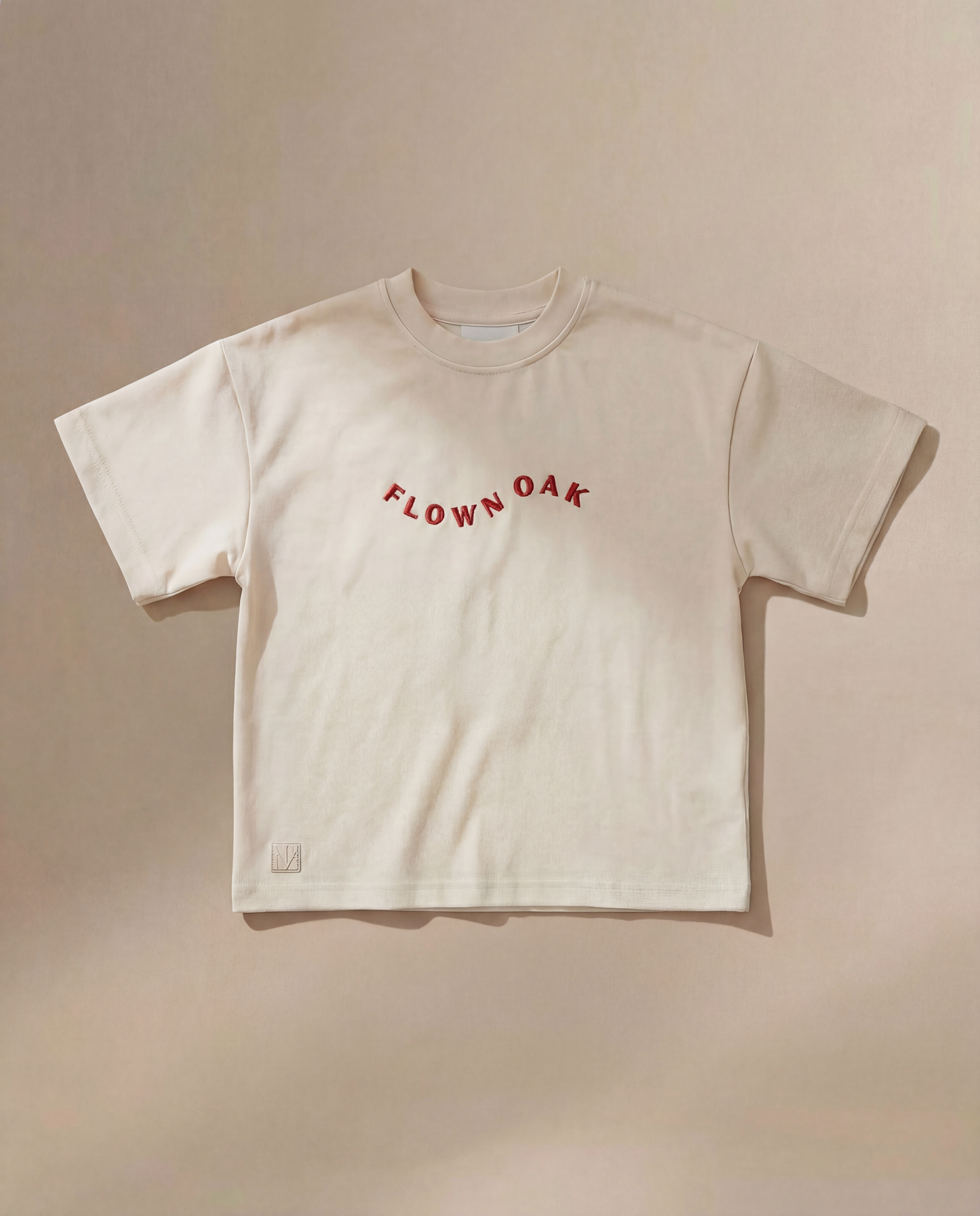 Beige t-shirt with 'Flown Oak' text on a beige background